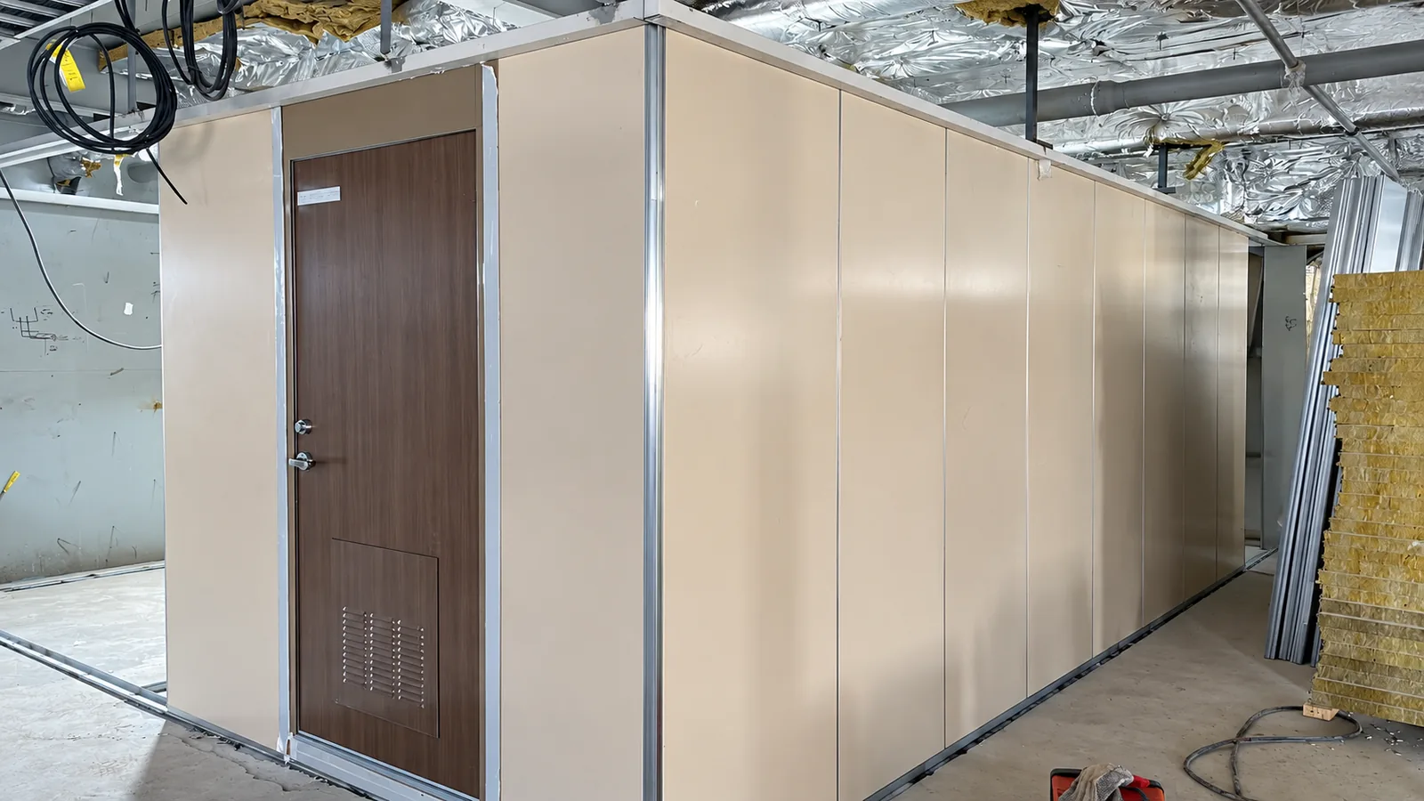 Hospital vessel interior wall panel and cabin door installation in progress